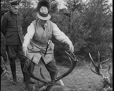 Nazi Officer Hermann Goering in Hunting Dress Showing His Colleagues a Line of Deer He..., 1931. Creator: British Pathe Ltd