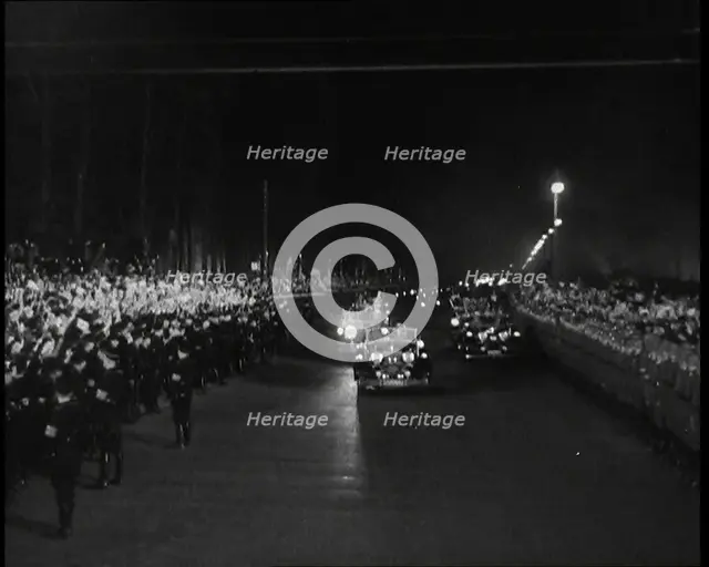 Nazi Party Staff Cars Driving Down a Wide Road in Berlin Edged With...Soldiers..., 1937 Creator: British Pathe Ltd.