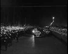 Nazi Party Staff Cars Driving Down a Wide Road in Berlin Edged With...Soldiers..., 1937 Creator: British Pathe Ltd