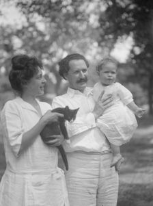 Nadelman, Mr. and Mrs., with baby and cat, standing outdoors, 1923 July 12. Creator: Arnold Genthe