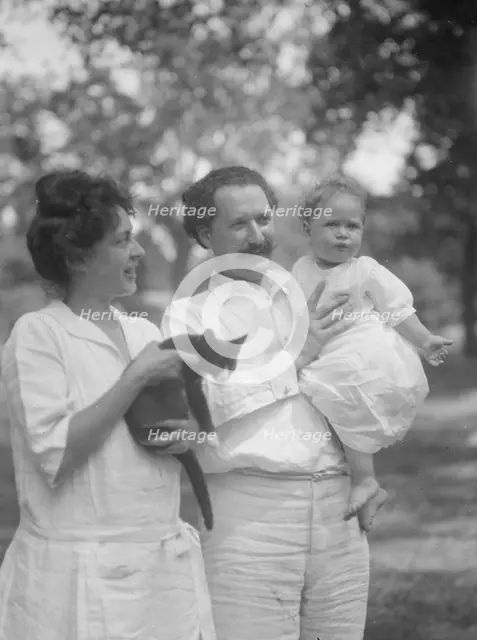 Nadelman, Mr. and Mrs., with baby and cat, standing outdoors, 1923 July 12. Creator: Arnold Genthe.
