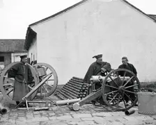 Nanking, Kiangsu province, China: three men examining a gun at the arsenal, 1871. Creator: John Thomson