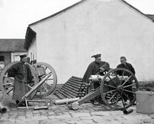 Nanking, Kiangsu province, China: three men examining a gun at the arsenal, 1871. Creator: John Thomson