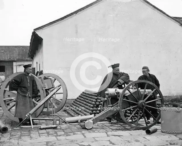 Nanking, Kiangsu province, China: three men examining a gun at the arsenal, 1871. Creator: John Thomson.