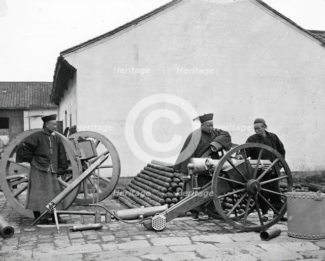 Nanking, Kiangsu province, China: three men examining a gun at the arsenal, 1871. Creator: John Thomson.
