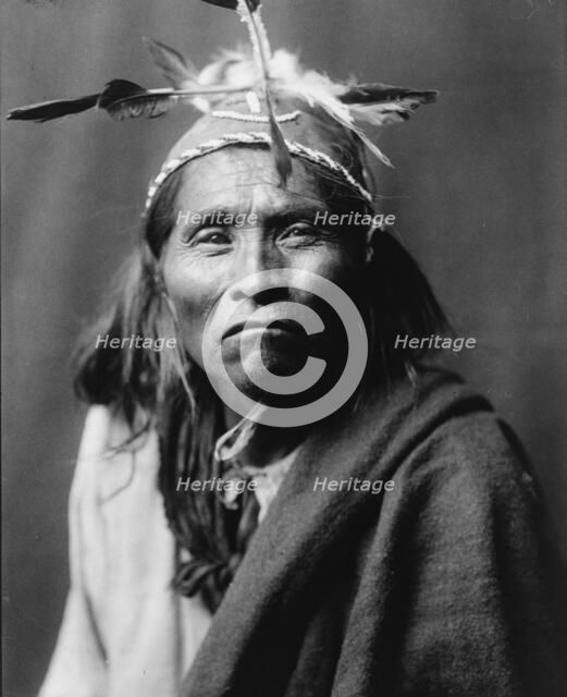 Ndee Sangochonh, Apache Indian, half-length portrait, facing front, c1906. Creator: Edward Sheriff Curtis.
