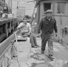 New England fisherman aboard their ship at Fulton fish market, New York, 1943. Creator: Gordon Parks