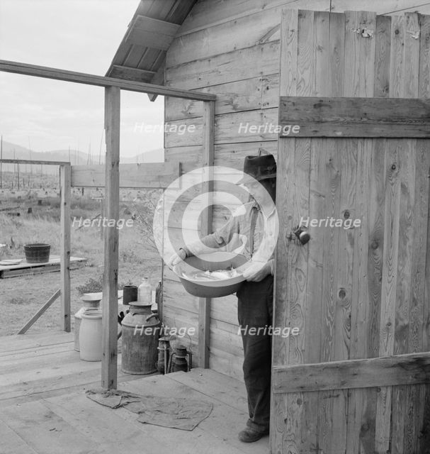 New settler shows fish he caught this morning, Priest River Valley, Bonner County, Idaho, 1939. Creator: Dorothea Lange.