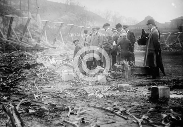 New York, NL & Philadelphia, NL players view fire damage, Polo Grounds, 1911. Creator: Bain News Service.