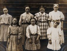 New York State Institute: a group of girls with Down's syndrome, standing on some steps, 1902. Creator: Unknown