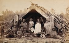 New Zealand: a group of Maori in front of a traditional building, 19th century. Creator: Unknown