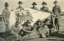 New Zealand soldiers with captured German flag, First World War, 1914, (c1920). Creator: Unknown