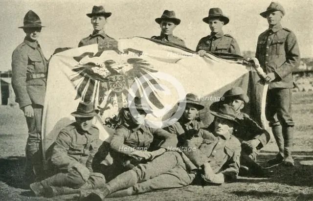 New Zealand soldiers with captured German flag, First World War, 1914, (c1920). Creator: Unknown.