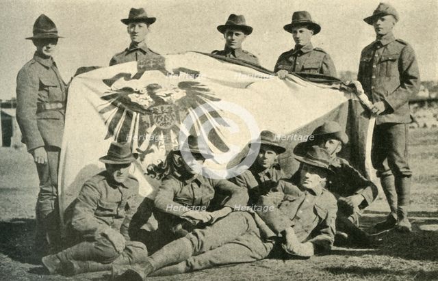 New Zealand soldiers with captured German flag, First World War, 1914, (c1920). Creator: Unknown.