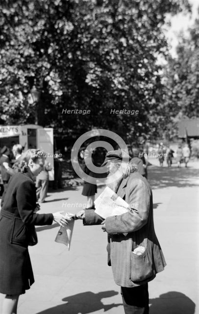 Newspaper seller, London, c1945-c1965. Artist: SW Rawlings
