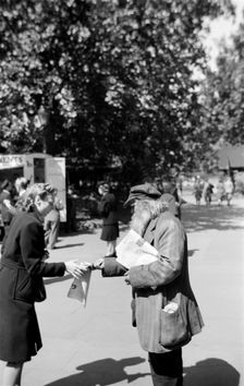Newspaper seller, London, c1945-c1965. Artist: SW Rawlings