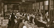Newsvendors gather to pick up the next day's newspapers to sell, Carmelite House, 20th century. Creator: Unknown