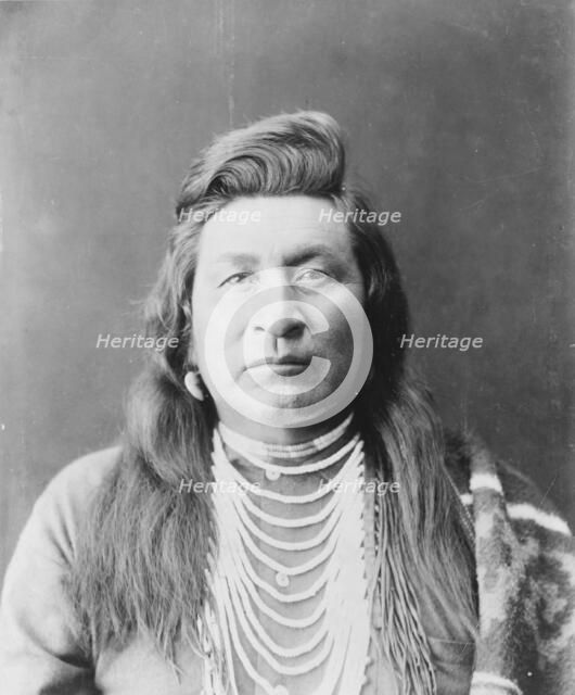 Nez Percé man, head-and-shoulders portrait, facing front, wearing bead necklace..., c1899. Creator: Edward Sheriff Curtis.