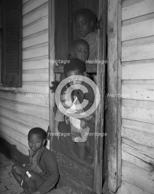 Negro children in the front door of their home, Washington (southwest section), D.C., 1942. Creator: Gordon Parks.