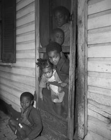 Negro children in the front door of their home, Washington (southwest section), D.C., 1942. Creator: Gordon Parks