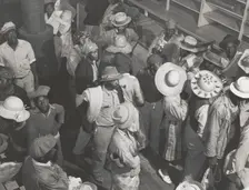Negro day laborers brought in by truck from nearby towns, waiting to be paid off and..., Oct 1939. Creators: Farm Security Administration, Marion Post Wolcott