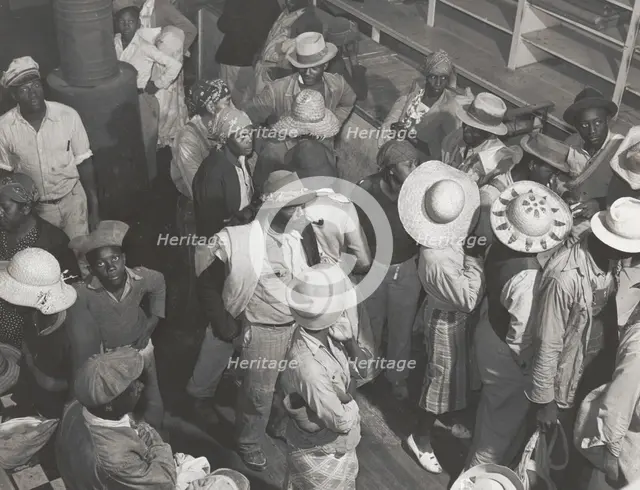 Negro day laborers brought in by truck from nearby towns, waiting to be paid off and..., Oct 1939. Creators: Farm Security Administration, Marion Post Wolcott.