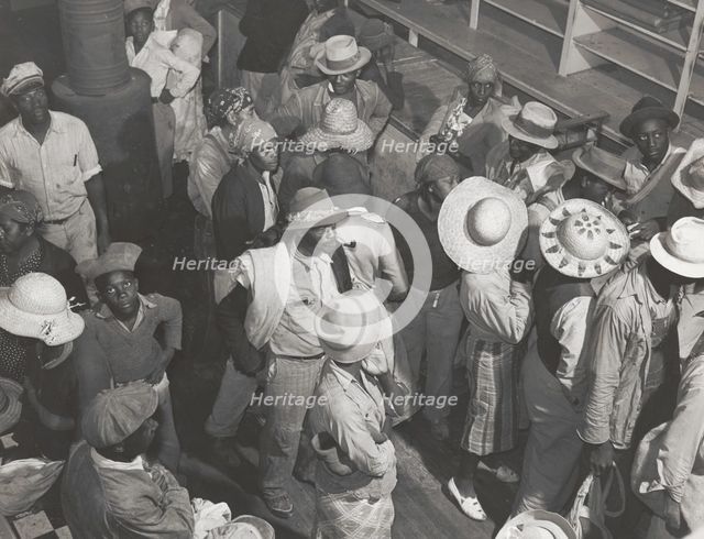 Negro day laborers brought in by truck from nearby towns, waiting to be paid off and..., Oct 1939. Creators: Farm Security Administration, Marion Post Wolcott.