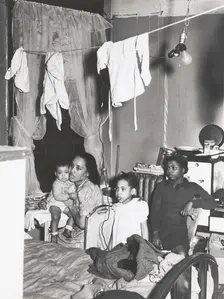 Negro family living in crowded quarters, Chicago, Illinois, April 1941. Creators: Farm Security Administration, Russell Lee