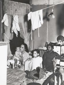 Negro family living in crowded quarters, Chicago, Illinois, April 1941. Creators: Farm Security Administration, Russell Lee