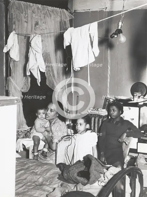 Negro family living in crowded quarters, Chicago, Illinois, April 1941. Creators: Farm Security Administration, Russell Lee.