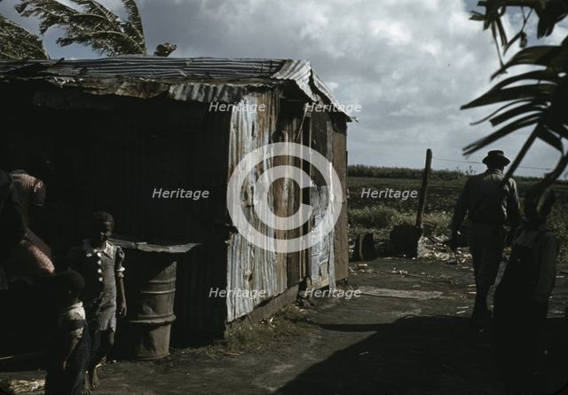 Negro migratory workers by a shack, Belle Glade, Fla., 1941. Creator: Marion Post Wolcott.