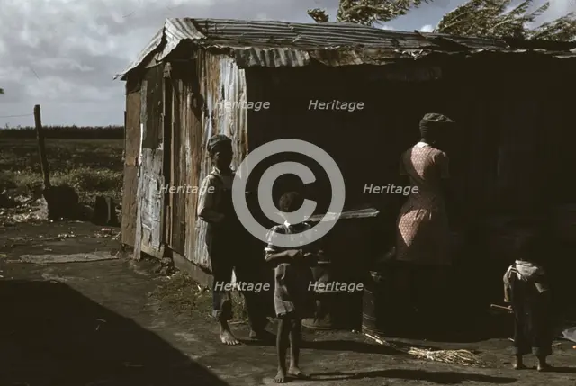 Negro migratory workers by a shack, Belle Glade, Fla., 1941. Creator: Marion Post Wolcott.