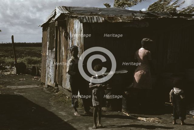 Negro migratory workers by a shack, Belle Glade, Fla., 1941. Creator: Marion Post Wolcott.