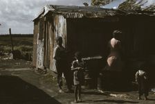 Negro migratory workers by a shack, Belle Glade, Fla., 1941. Creator: Marion Post Wolcott