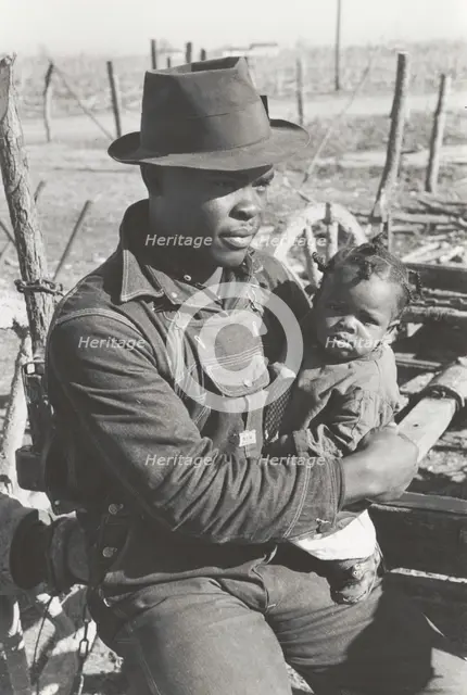 Negro sharecropper and son who will be resettled, Transylvania Project, Louisiana, Jan 1939. Creators: Farm Security Administration, Russell Lee.