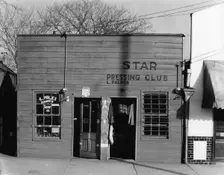 Negro shop, Shop fronts, laundry and barber shop, Vicksburg, Mississippi, 1936. Creator: Walker Evans