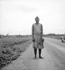 Negro woman carrying her shoes home from church, Mississippi Delta, 1936. Creator: Dorothea Lange