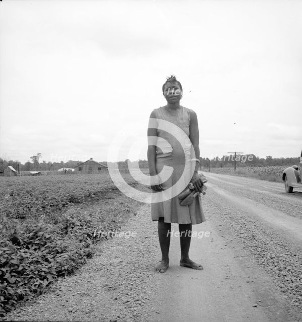 Negro woman carrying her shoes home from church, Mississippi Delta, 1936. Creator: Dorothea Lange.