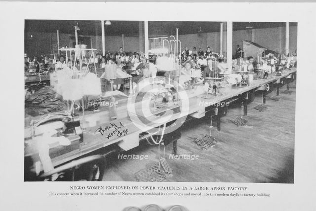 Negro women employed on power machines in a large apron factory, 1922. Creator: Unknown.