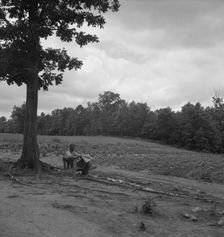 Negro tenant farmer reading paper on a hot Saturday afternoon, Chatham County, North Carolina, 1939. Creator: Dorothea Lange