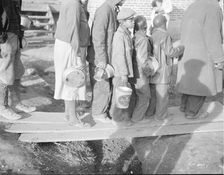 Negroes waiting for food in the Forrest City, Arkansas, refugee camp, 1937. Creator: Walker Evans