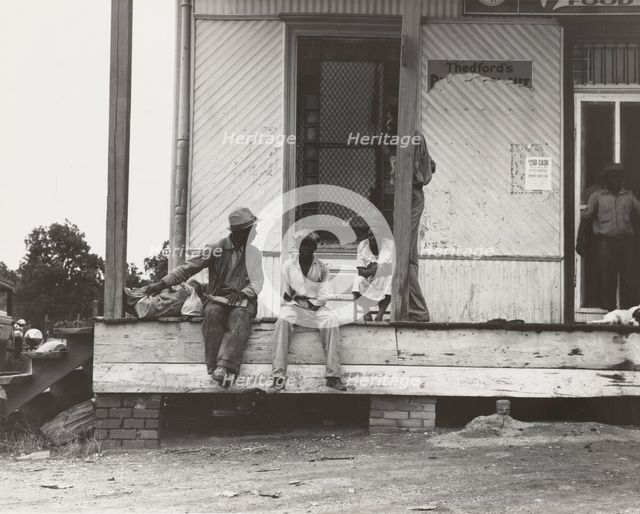 Negroes hanging around the plantation store. Mississippi Delta, 1936. Creators: Farm Security Administration, Dorothea Lange.