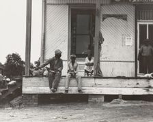 Negroes hanging around the plantation store. Mississippi Delta, 1936. Creators: Farm Security Administration, Dorothea Lange