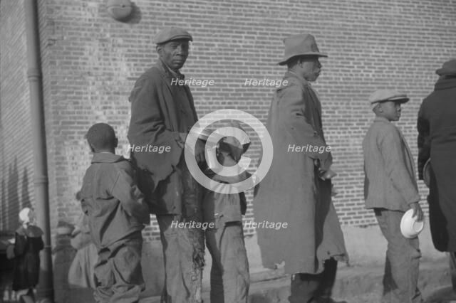 Negroes in the lineup for food at the flood refugee camp, Forrest City, Arkansas, 1937. Creator: Walker Evans.