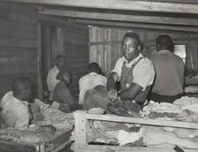 Negroes in bunkhouse in strawberry fields near Hammond, Louisiana; Note crude..., April 1939. Creators: Farm Security Administration, Russell Lee