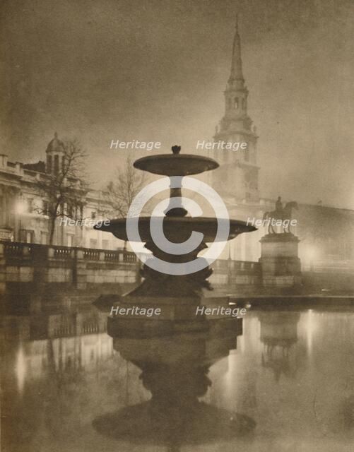 'Night Rain Has Turned The Pavements To A Pool of Reflections', c1935. Creator: Calkin.