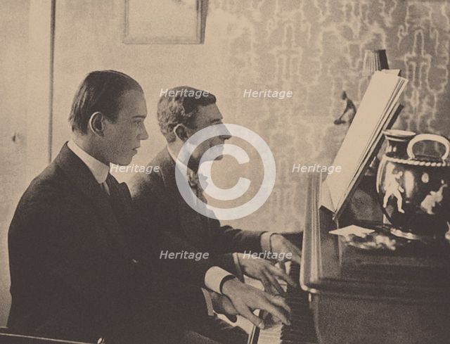 Nijinsky and Maurice Ravel at the piano playing a score from Daphnis and Chloe, 1912. Artist: Anonymous  