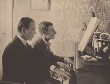 Nijinsky and Maurice Ravel at the piano playing a score from Daphnis and Chloe, 1912. Artist: Anonymous