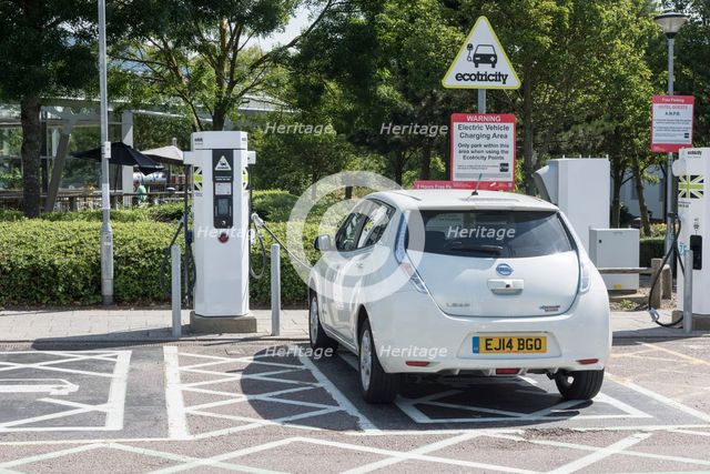 Nissan Leaf at elctric charging point 2015. Creator: Unknown.