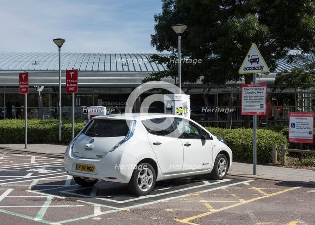 Nissan Leaf at elctric charging point 2015. Creator: Unknown.